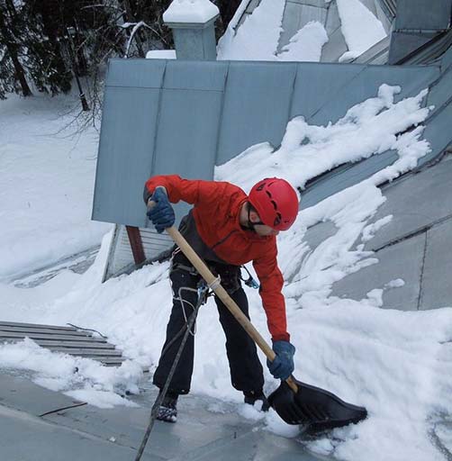 Уборка снега с крыши промышленными альпинистами